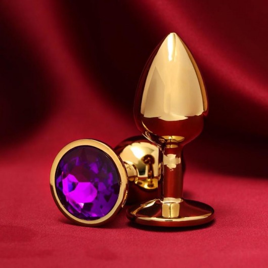 Золотистая анальная пробка с фиолетовым кристаллом - Сима-Ленд - купить с доставкой в Тюмени